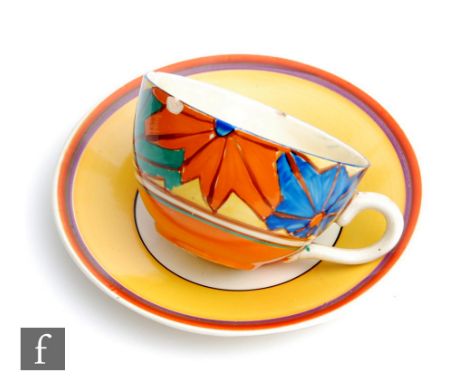 A Clarice Cliff Globe shape tea cup circa 1929, hand painted in the Umbrellas pattern with stylised sunburst motifs with matc