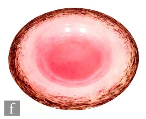 A 1930s Monart shallow glass bowl, shape DF, with deep purple and aventurine mottled rim to a pink ground, diameter 29cm. 