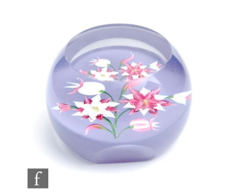 A Caithness faceted glass paperweight titled Parma Violent, designed by Rosette Fleming, with a lamp work floral spray in pin