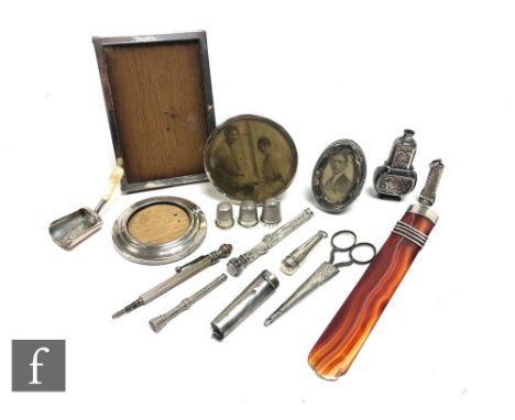 A small parcel lot of assorted silver and white metal items to include four photograph frames,&nbsp; an agate letter opener, 