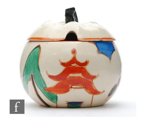 A Clarice Cliff apple shaped preserve pot and cover circa 1931, hand painted in the Kew pattern, with a stylised pagoda and t