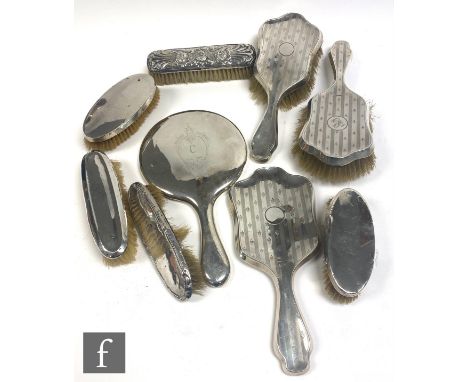 Eight assorted hallmarked silver backed hair brushes of plain form and with engine turned decoration, with a similar hand mir