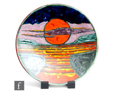 A later 20th Century Poole Pottery studio charger designed by Tony Morris and decorated with a sunset against a tonal landsca