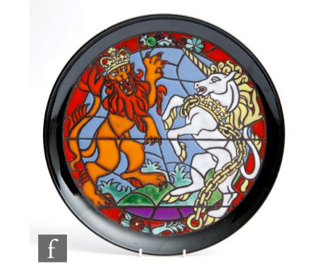 A Poole Pottery commemorative charger designed by Tony Morris to celebrate the Queen's Silver Jubilee decorated with a lion a