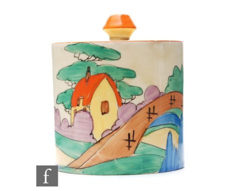 A Clarice Cliff drum shaped preserve pot and cover circa 1932, hand painted in the Orange Roof Cottage pattern with a stylise