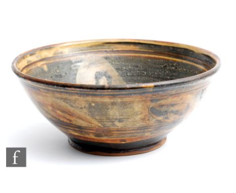 A large Winchcombe Pottery high sided bowl possibly decorated by Michael Cardew with brush strokes in ochre against a brown a