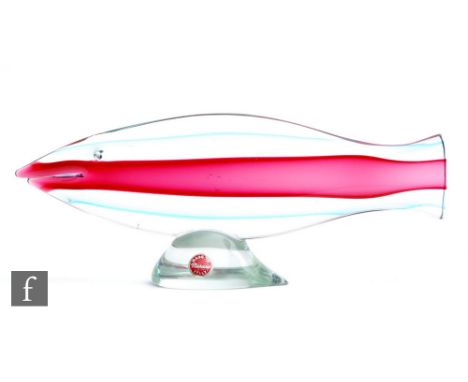 A post war Murano glass sculpture of a stylised fish, the simple form with ruby core cased in green and clear, with applied c