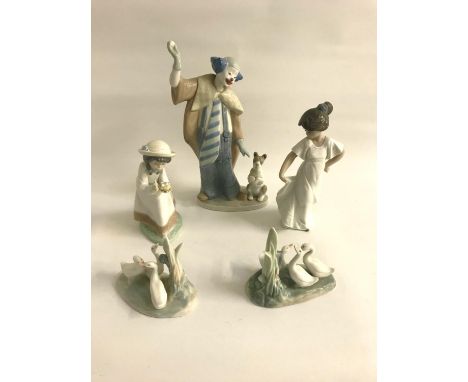 FIVE NAO PORCELAIN FIGURINES
including a clown with a dog, 29cm high,; a young girl holding her dress, 22.5cm high; a young h