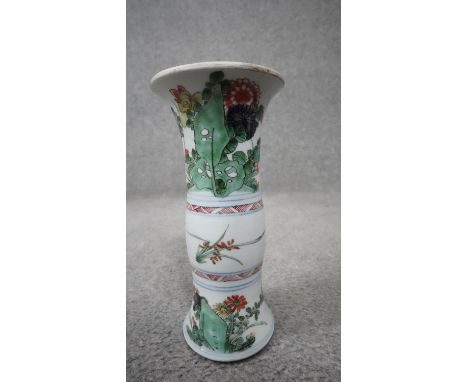 A Chinese Kangxi style Famille Verte ceramic vase decorated with flowers and leaves. Unglazed foot. H.23cm 