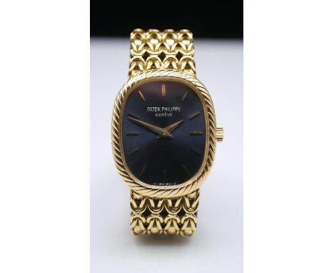 A vintage Patek Philippe Ellipse ladies 18 carat watch. With oval shaped face with blue dial and gold batons, mesh 18 carat y