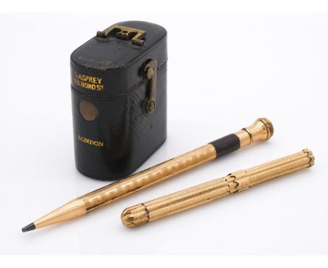 Two rolled gold pens and a travel Asprey's leather gilded vesta case. One of the rolled gold geometric design pens has retrac