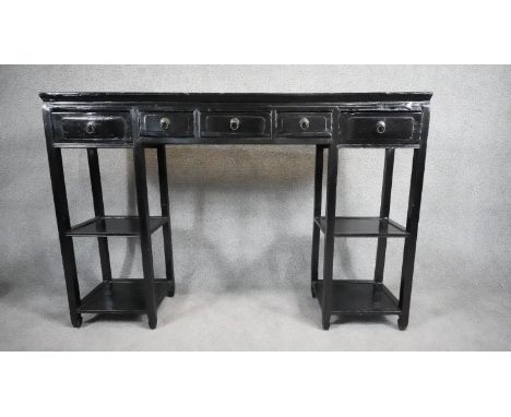 A Chinese black lacquered console table fitted with frieze drawers on square stretchered open pedestals. H.92 W.136 D.27cm 