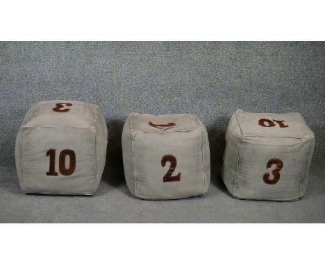 Three denim dice weighted pouffe stools with brown leather numbers. H.40cm