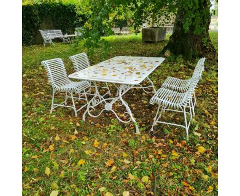 AN ARRAS STYLE WROUGHT IRON TABLE AND FOUR CHAIRSpainted white with 'horse hoof' feet, the chairs 81cm high x 43cm wide x 55c