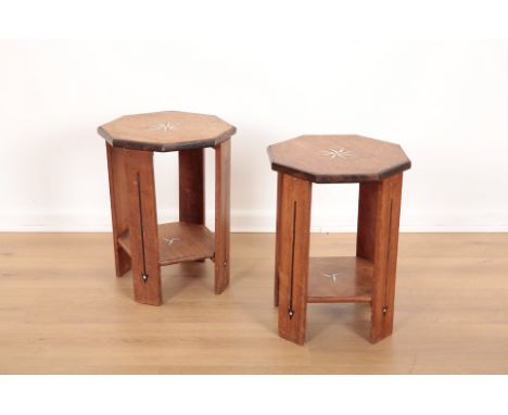 A PAIR OF HEXAGONAL OAK SIDE TABLES IN LIBERTY STYLEearly 20th century, ebony and ivory starburst to the tops, one lower shel