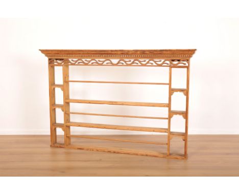 A PINE WALL MOUNTED OPEN SHELF OR DRESSER TOPwith dentil cornice and pierced foliate fretwork beneath, two shelves with plate