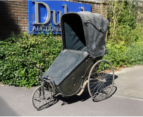 A VICTORIAN INVALID OR BATH CHAIRwith original buttoned interior and lower fringed curtain to the seat, tilter steering and l