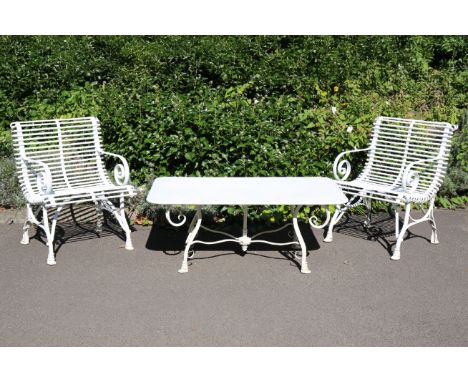 AN ARRAS STYLE WROUGHT IRON COFFEE TABLE AND TWO ARMCHAIRSpainted white and with 'horse hoof' feet, the chairs 84cm high x 64