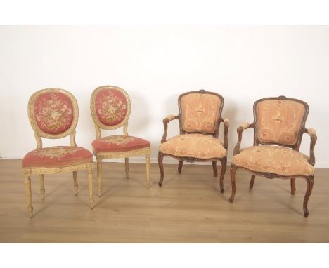 TWO PAIRS OF FRENCH ARMCHAIRSthe first of Louis XVI style but 19th century, with oval backs and upholstered in pink floral ta