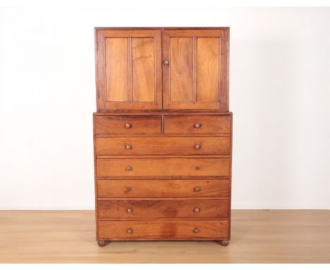 A CONTINENTAL HARDWOOD HOUSEKEEPER'S CUPBOARDmid-20th century, two front doors enclosing a shelf, two small drawers above fiv