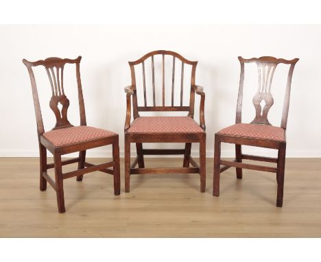 THREE GEORGE III DINING CHAIRSincluding one armchair with shield shaped back and spindles, 95cm high x 58.5cm wide x 45cm dee