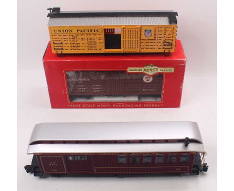 Three G gauge plastic 45mm wagons to include a Santa Fe US mail coach, in maroon, a Union Pacific Box Car, in yellow, no bogi