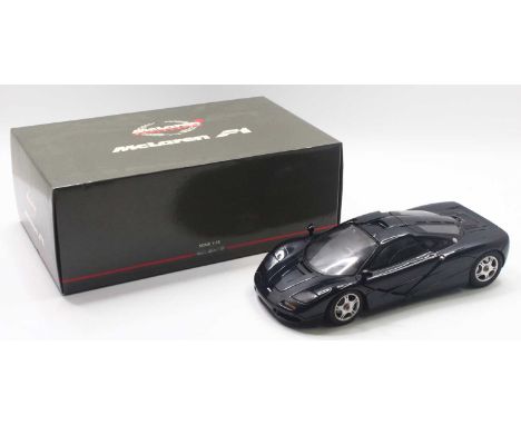 Minichamps 1/12 scale modern issue diecast model of a Mclaren F1 Roadcar in dark blue/black body, housed in a polystyrene pac