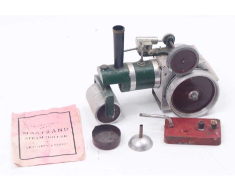 A Mastrand spirit-fired model traction engine comprising of green body with red hubs and base metal components, single oscill
