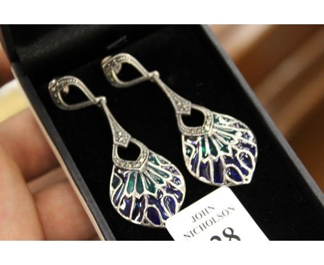 A pair of silver and enamel earrings.