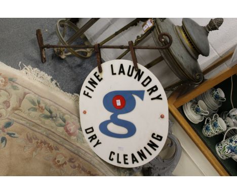 A wrought iron bracket with Dry Cleaning sign.