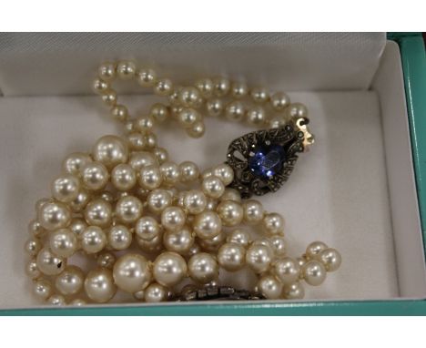 Pearl necklaces with marcasite clasps.