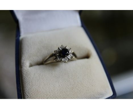 An 18ct gold diamond and sapphire ring.