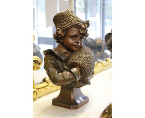 A good large continental bronze glazed pottery bust of a young girl, her hands in a muff.