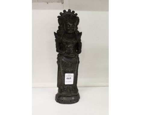 A dark patinated bronze figure of an eastern deity.