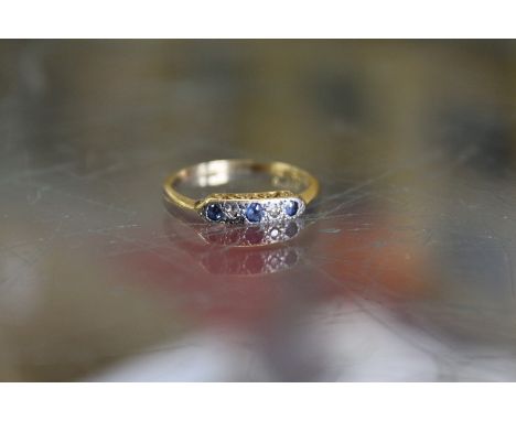 An 18ct gold, platinum, diamond and sapphire ring.