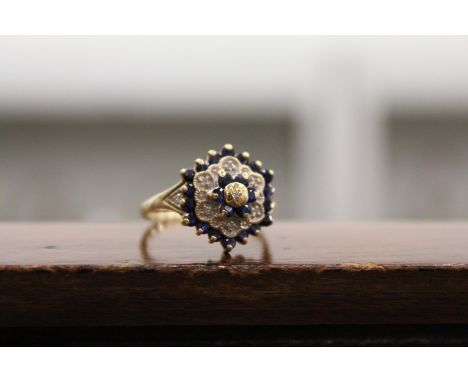 A good gold, diamond and sapphire cluster ring.