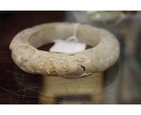 A large Chinese carved jade bangle.