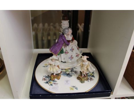 A porcelain figural lamp, a pair of figures and a boxed porcelain stand.