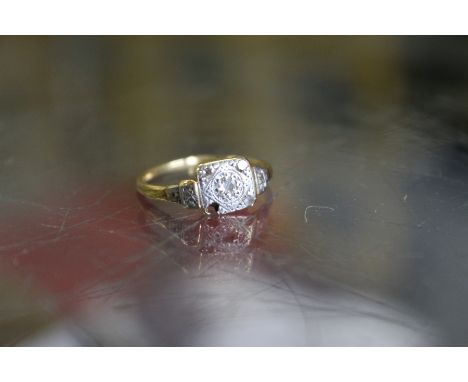 A gold and diamond ring (lacking one diamond).