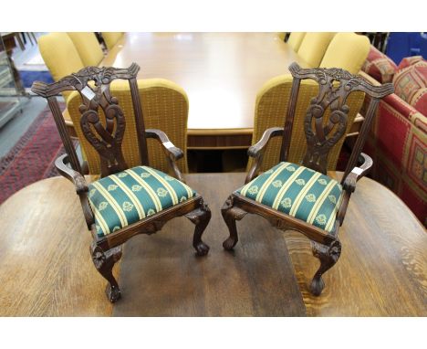A pair of Chippendale style miniature mahogany armchairs.
