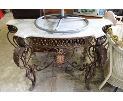 A wrought iron and marble top serpentine shaped console table.