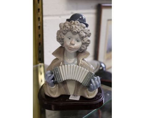 A Lladro bust of a clown playing an accordion.