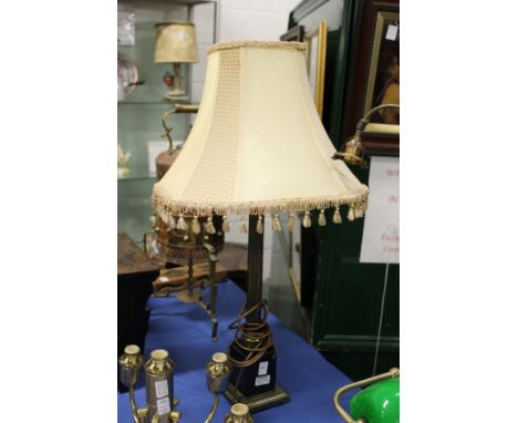 A Corinthian column style table lamp with shade.