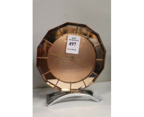 An Art Deco pink glass mantle clock.