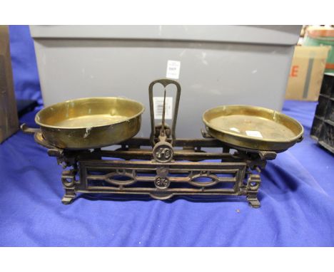 An ornate cast iron and brass scales.
