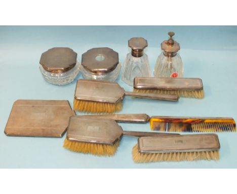 A nine-piece silver dressing table set of stepped octagonal design, with engine-turned engraving, comprising: scent bottle, (