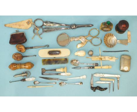 Two button hooks, each finial with grotesque mask carved from a nut, with ceramic eyes and other small collectable items. 