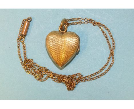A small engine-turned gold heart-shaped locket on 9ct gold chain, gross weight 4.2g. 