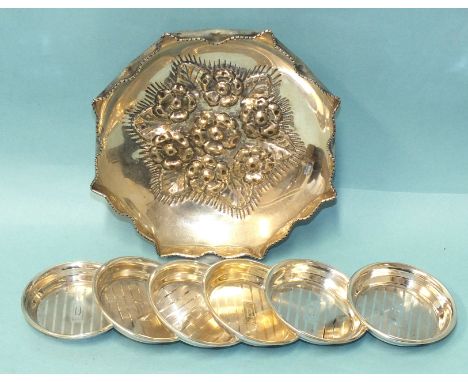 An octagonal 925 silver dish, the base embossed with flowers and raised on three feet, 16cm diameter and a set of six engine-