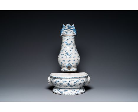 Fullt title: A blue and white Brussels faience fountain with basin, 18th C.Description: Dim.: 38,5 x 23 x 15 cm (the basin)H.